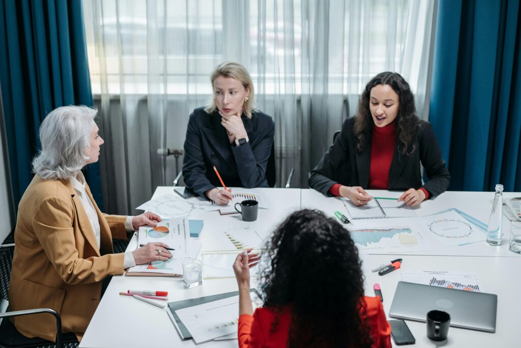 pexels-photo-8424530-8424530 Four professional women engaged in a productive office meeting, discussing business plans.